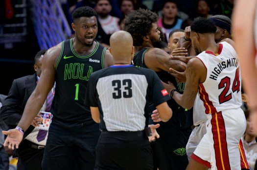 New Orleans Pelicans forward Zion Williamson (1) argues with the referee after being fouled by Miami Heat forward Kevin Love earlier while Pelicans forward Naji Marshall, center, and Miami Heat forwards Haywood Highsmith (24) and Jimmy Butler, top right, get into a scuffle during the second half of an NBA basketball game in New Orleans, Friday, Feb. 23, 2024. Marshall and Butler were later ejected. (AP Photo/Matthew Hinton)