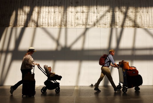 Travelers walk with luggage in the international terminal at Los Angeles International Airport on August 31, 2023 in Los Angeles, California. (Photo by Mario Tama/Getty Images)
